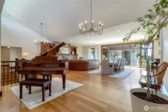 As you enter the heart of the home you are welcomed by rich hardwood floors, high vaulted ceiling and abundant natural light! Walls of glass beyond the dining area invite you to the outdoor living space. Wonderful areas to gather both inside and out!