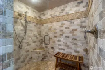 Large walk-in shower with glass door.