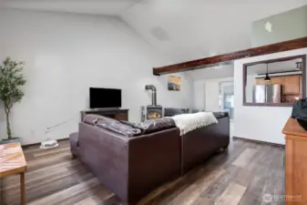 This great room concept offers vaulted ceiling, exposed beams, lovely dining room area and a large living/family room set up.