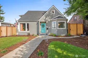 Large corner lot with manicured landscaping.