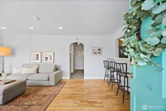Teal front door opens into living room.