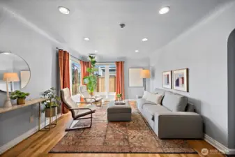 Living space with abundant natural light coming through corner picture windows.