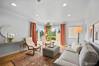 Living space with abundant natural light coming through corner picture windows.