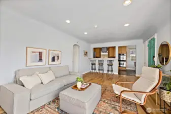 Living room space and bar eating area attached off kitchen opening.