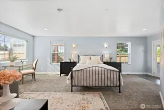 Generous primary bedroom suite full of natural light with multiple windows. Access to covered back deck through french doors in primary bedroom.