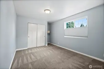 Large 2nd Bedroom on main floor with closet & large window to wake up to natural light.