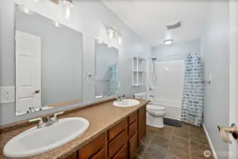 3rd Full bathroom upstairs with double-sink vanity & dual mirrors, and tub/shower combo.