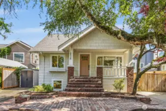 Endless curb appeal with an enchanting brick pathway providing Old World charm leading up to covered front porch - a characteristic of the Craftsman home.