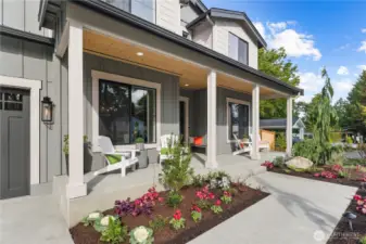 Extra-long covered front porch. Great for relaxing in rockers and visiting with neighbors. Beautiful, irrigated planting beds by the walkway. Enjoy seasonal flowers and blooms all year long.