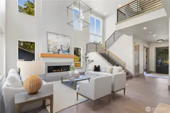 View back to the entry foyer and open staircase leading to the second floor. 10' ceilings on the main floor and 8' doors on the both levels. Large storage space under the stairway. This home also has great natural lighting with its many oversized windows.