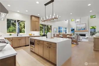 Chef's waterfall island, decorative chandelier, bar seating for 3-4, picturesque kitchen sink window looks out to the grassy backyard and neighboring Evergreens.