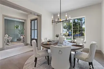 Elegant dining room is perfect for a round table. Sun-filled room off the entry with chandelier. niched space on the unseen wall opposite the window for an heirloom furniture piece.