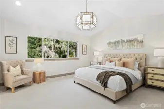 Elegant primary bedroom with ceiling, chandelier, and serene Evergreen outlook.