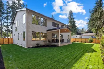 Glorious level backyard, sprawling lawn, covered patio, and fully-enclosed yard.