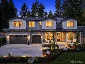 Such a gorgeous home all lit up with accent and pathway lighting. Robust landscaping with fall color and sprawling front lawn. It's a showstopper in the evening.