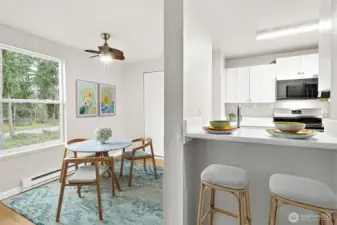 Virtually staged dining room and casual eating bar at