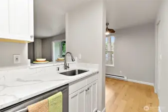 Kitchen is open to dining room and living room thanks to the convenient eating bar
