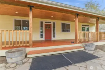 Front entrance with a slate patio & huge 600' fully covered front porch with soffit lighting & gutters has lots of room for a hot tub, porch swing, & outdoor dining to enjoy sunsets.
