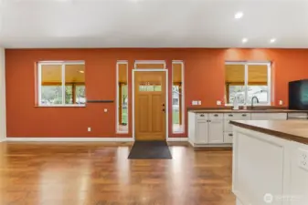 Large open concept floorplan living room/kitchen with a huge island is built for modern family living & get togethers. Lifeproof Pergo  vinyl plank flooring is beautiful & durable.