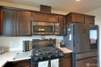 Stove, refrigerator to the right.