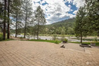 Walk out your back door onto a large brick patio to a fire pit and down to the river