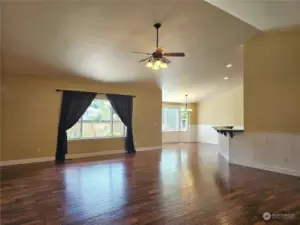 Bright and inviting open floor plan with soaring ceilings and Acacia engineered floors throughout living area.