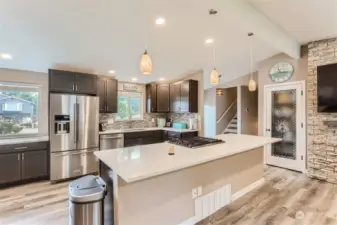 Beautiful open kitchen with new cupboards, Quartz countertops, sink & faucet & stainless Steele appliances