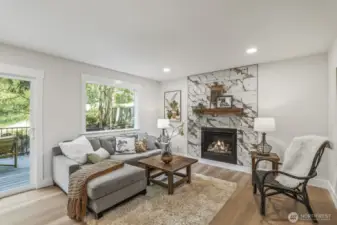 Gas fireplace with custom tile and mantel creates a warm and inviting gathering space.