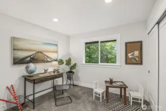At the top of the stairs, you’ll find one of the four bedrooms—an ideal space for a den or flexible use.