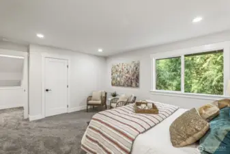 This light-filled primary suite overlooks the lush greenbelt.