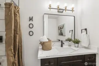 New lighting and fixtures elevate the luxury feel of the primary bathroom.
