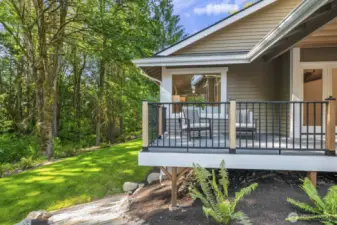 Steps lead off the front of the home, showcasing the beautiful greenbelt and serene natural surroundings.
