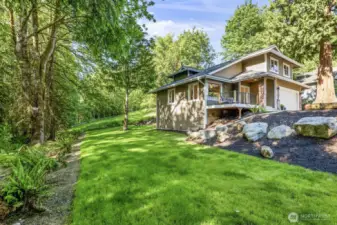 A spacious side yard runs along the greenbelt, offering ample room for yard games, entertaining, and enjoying the outdoors.