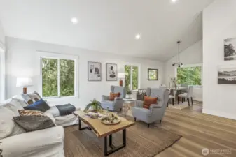 Living room just off the foyer, featuring fresh interior paint and new LVP flooring that extend throughout the entire main living space.