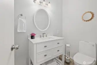 Main Level Half Bath with new floor, new vanity, new toilet.
