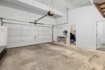 3 Bay Garage. 3rd Bay has been converted to a flex space through the door on the left and an office through the door on the right of the image. The garage door rails and system are in tact & can easily convert back to 3rd car garage bay.