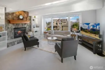 Living room with wood wrapped beams and large windows to capture the mountain views and natural light!  Wonderful stone hearth with gas fireplace.