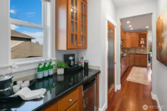 Butler's pantry with wine cooler and pantry tucked right off the kitchen.