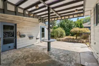 Covered patio connects the house to the shop