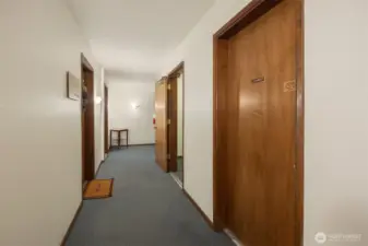 Condo is at the end of the hall on the left.  This photo shows the door to the community laundry room and to the stairs going up to the front door of the complex.