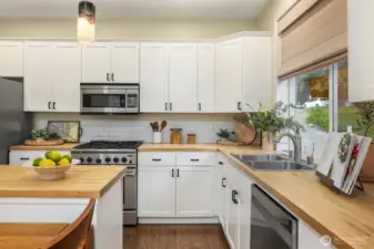 Lots of storage afford functional practicality in this well-equipped kitchen. Don't miss the slide out shelving.