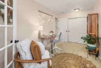 French doors open onto the bonus room, from the primary bedroom.