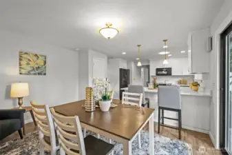 Another view of this versatile area highlights its open connection to the kitchen. With plenty of natural light and room to gather, it works beautifully as either a dining space or an informal family room.