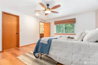 Primary bedroom looks over the spacious rear deck and backyard.