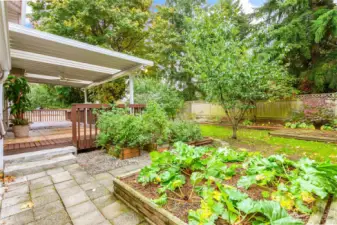 Fully fenced backyard with raised beds and a 12'x48' partially covered deck w/ceiling fan!