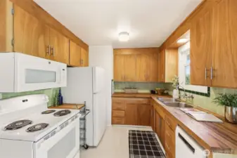 Good amount of storage in this sweet kitchen!  Vintage wall tiles are in great condition.  A Boesch dishwasher was added in 2023 and other appliances are newer.  Flooring is warm, quiet and durable cork!