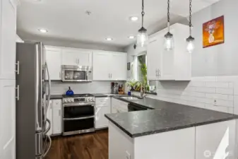 Designed for both everyday living and entertaining, the kitchen opens naturally to the nook and adjacent living room.