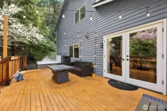 From the deck, enjoy generous outdoor space that leads to the hot tub.  Perfect for gatherings or quiet evenings.