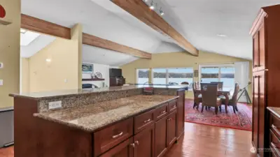 Tall granite countertop and lovely cherry wood cabinets store all of your kitchen gadgets. Enjoy cooking here with friends and family.