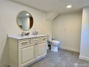 Half bath that also serves as laundry. Heated floors.